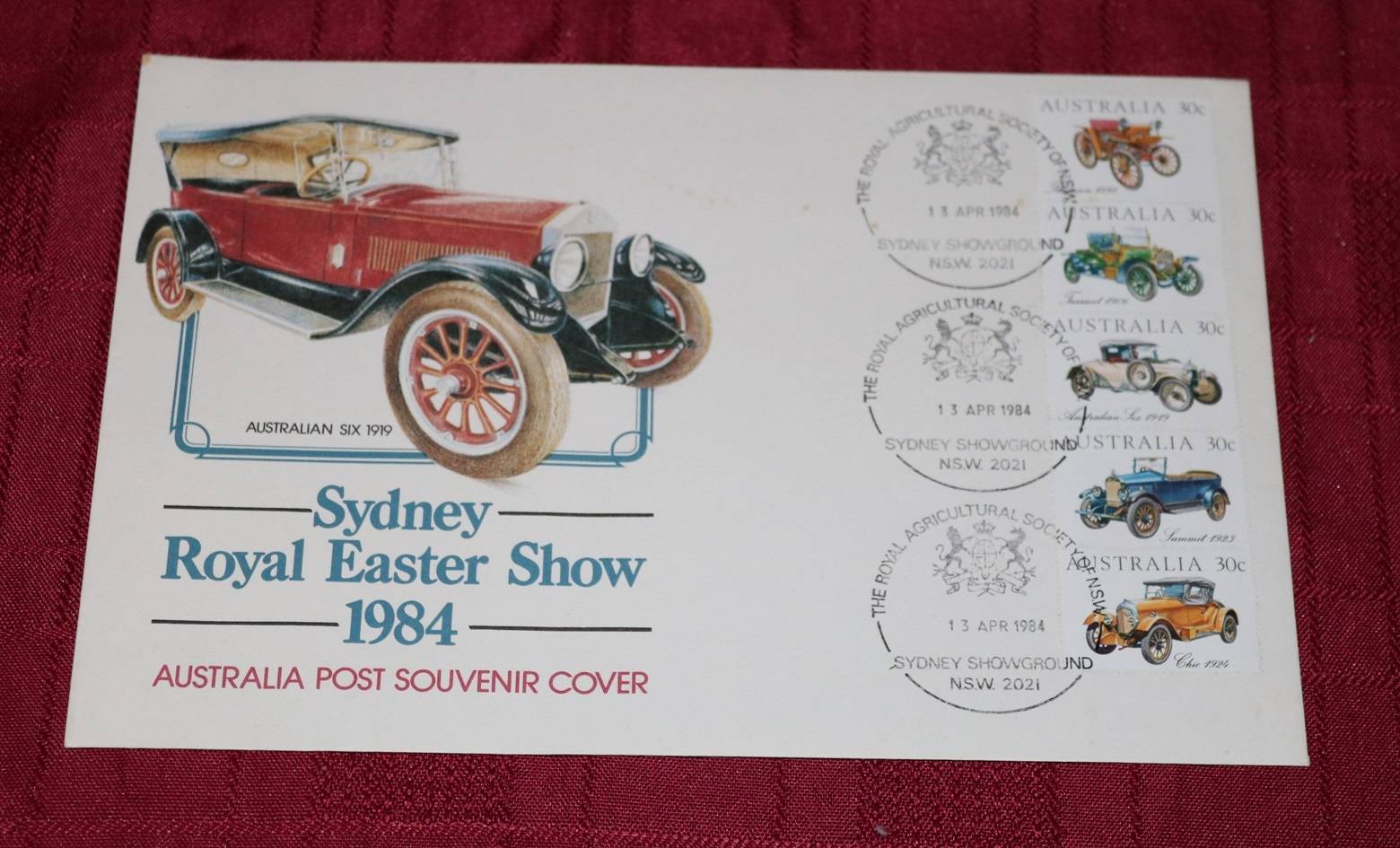 Postcard with stamps featuring classic Australian cars